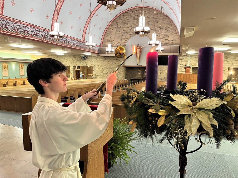 Sophomore Alex Tucker lights the first candle of the Advent wreath 