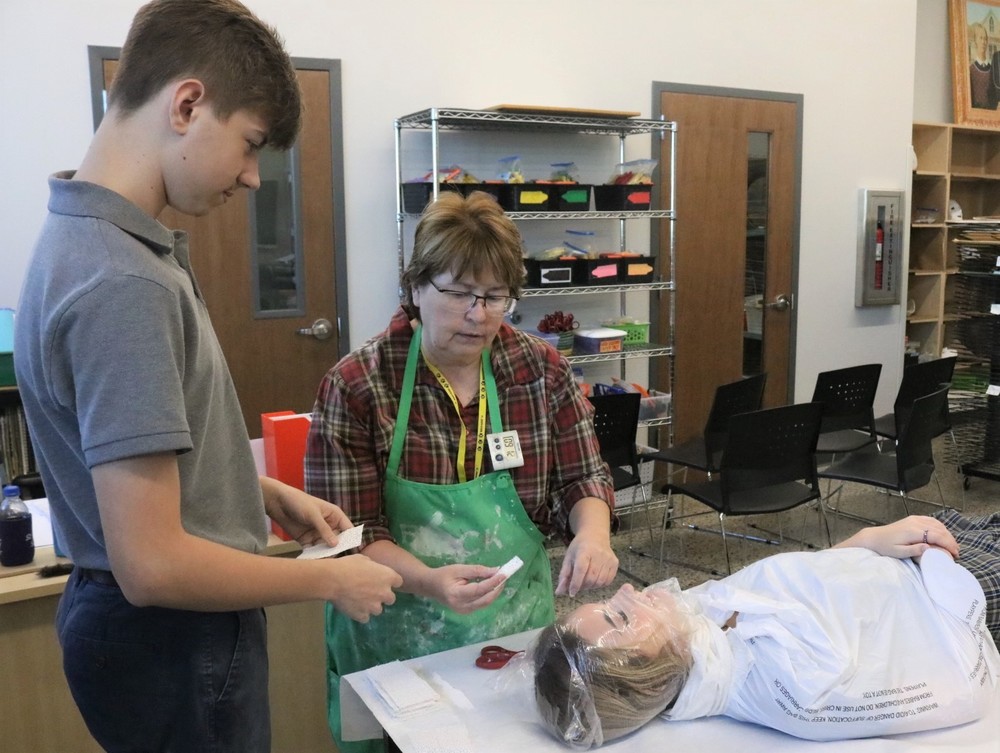 Sophomore art students spent a few weeks creating plaster masks .