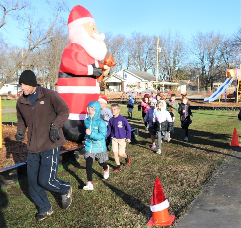 Physical Education teacher Brent Bruich leads kids on a jingle jog before the holidays. 