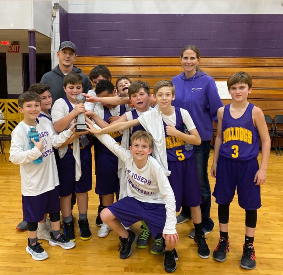 St. Joseph 4th grade Boy Basketball Team holding their trophy