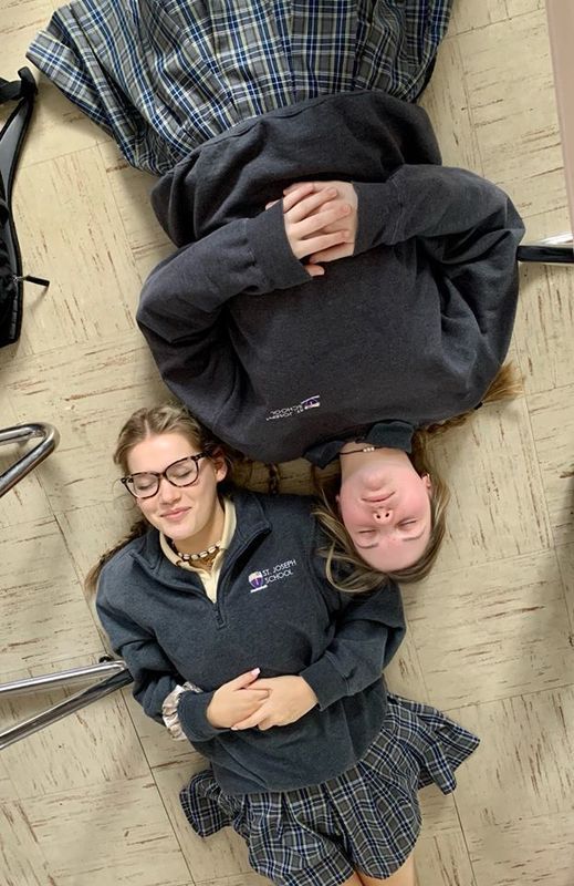 freshmen meditate in classroom